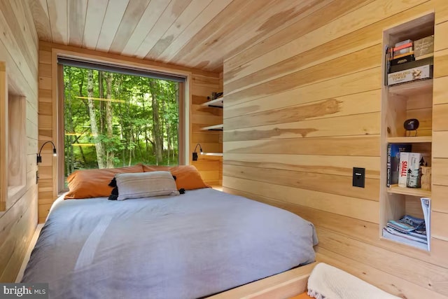 bedroom featuring wooden walls and wood ceiling