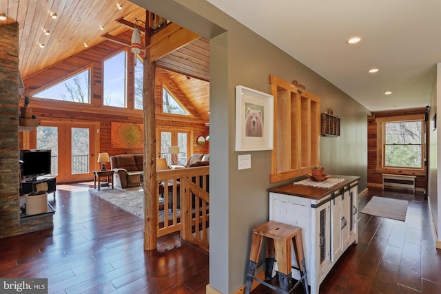 corridor featuring wooden ceiling, dark wood-style floors, vaulted ceiling, and recessed lighting