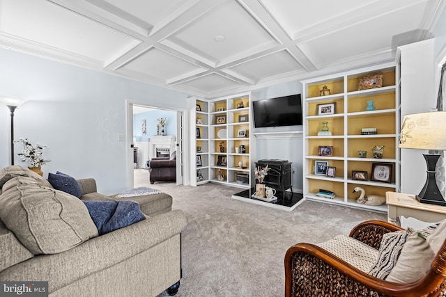 carpeted living room with beam ceiling, a wood stove, coffered ceiling, and built in shelves