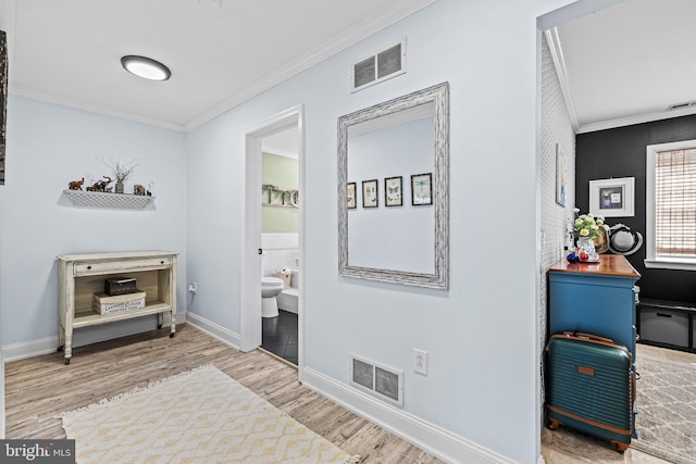 interior space featuring crown molding, visible vents, and wood finished floors