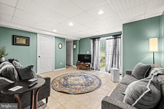 living room with recessed lighting, tile patterned flooring, and baseboards