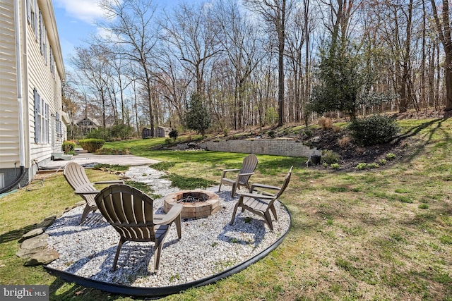 view of yard with an outdoor fire pit and a patio