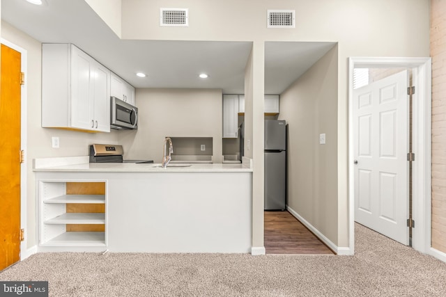 1516 Lancaster St, Baltimore, MD 21231 - kitchen with appliances with stainless steel finishes, carpet flooring, white cabinetry, recessed lighting, and open shelves