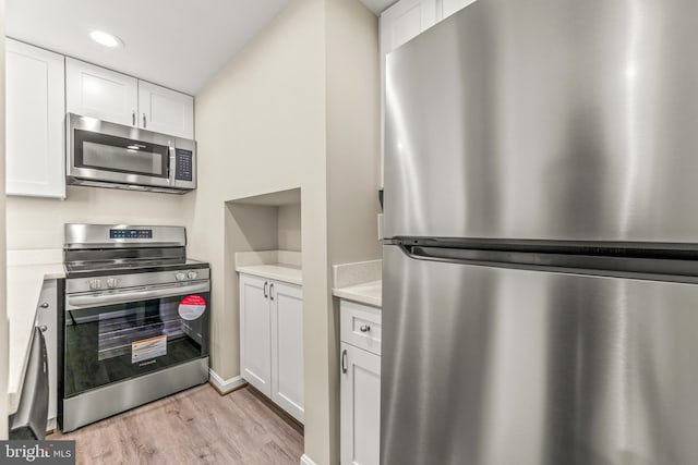 1516 Lancaster St, Baltimore, MD 21231 - kitchen with stainless steel appliances, light wood-type flooring, white cabinetry, light countertops, and recessed lighting