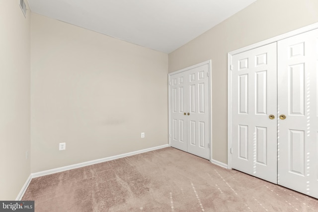 1516 Lancaster St, Baltimore, MD 21231 - unfurnished bedroom featuring carpet flooring and two closets