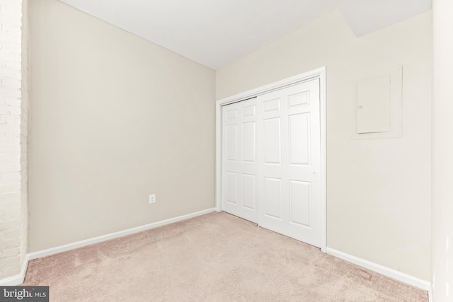 1516 Lancaster St, Baltimore, MD 21231 - unfurnished bedroom featuring light colored carpet, electric panel, and a closet