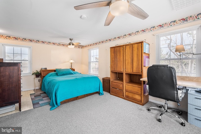 bedroom featuring a ceiling fan, carpet flooring, and visible vents