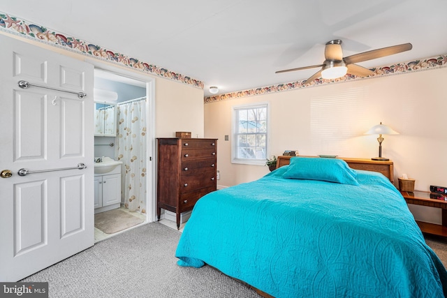 bedroom with carpet, ensuite bath, and ceiling fan