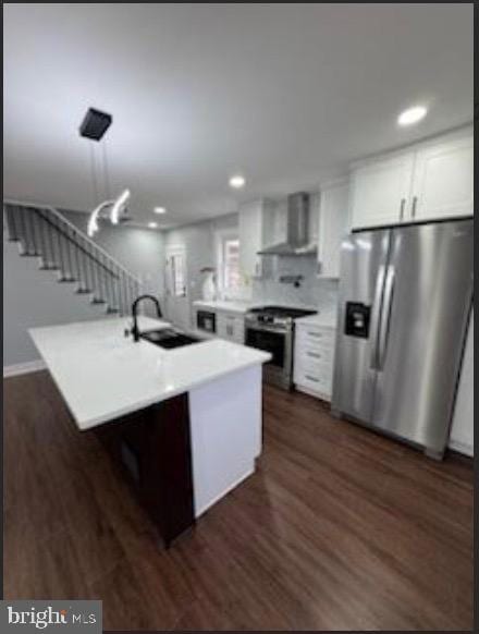51 S Pine Ave, Maple Shade, NJ 08052 - kitchen with stainless steel appliances, dark wood-type flooring, a sink, wall chimney range hood, and white cabinets