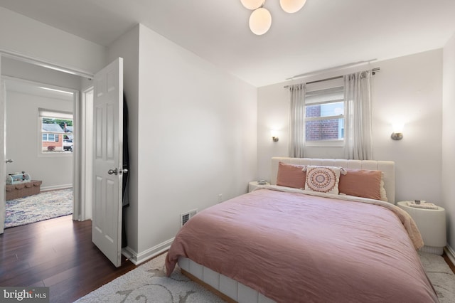 11809 Old Drovers Way, Rockville, MD 20852 - bedroom featuring multiple windows, wood finished floors, and baseboards