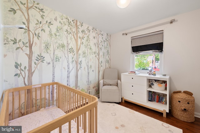 11809 Old Drovers Way, Rockville, MD 20852 - bedroom featuring wood finished floors, a crib, wallpapered walls, and baseboards