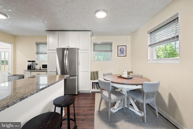 11809 Old Drovers Way, Rockville, MD 20852 - kitchen featuring freestanding refrigerator, dark wood-type flooring, healthy amount of natural light, and dark stone counters