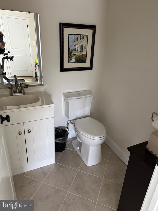 8537 Pine Springs Dr, Severn, MD 21144 - bathroom featuring baseboards, toilet, tile patterned flooring, and vanity