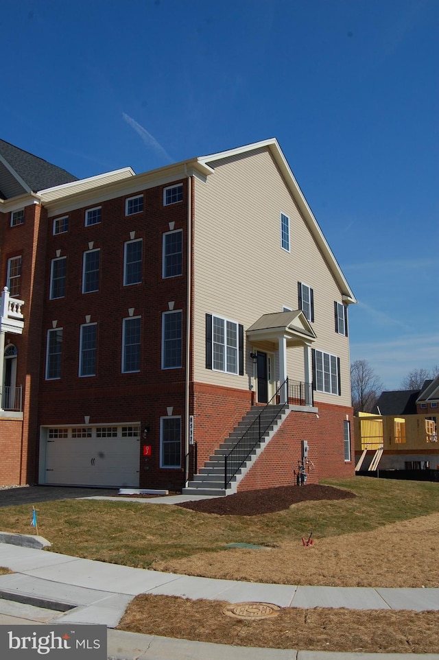 8537 Pine Springs Dr, Severn, MD 21144 - view of property with brick siding, a front yard, stairway, and an attached garage
