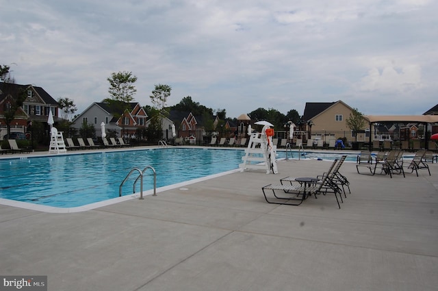 8537 Pine Springs Dr, Severn, MD 21144 - community pool with a residential view, fence, and a patio area