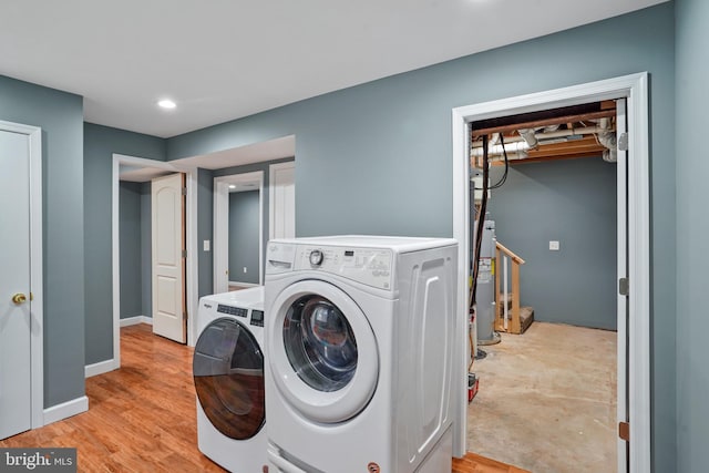 7058 Crespo Ln, Manassas, VA 20112 - washroom with washer and clothes dryer, water heater, recessed lighting, and light wood-type flooring