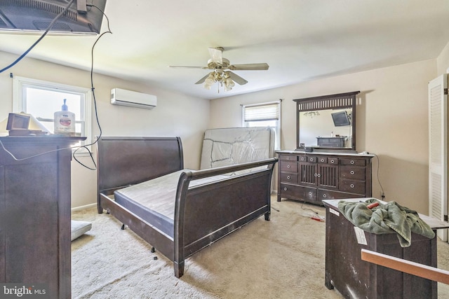 carpeted bedroom featuring a wall mounted AC and ceiling fan