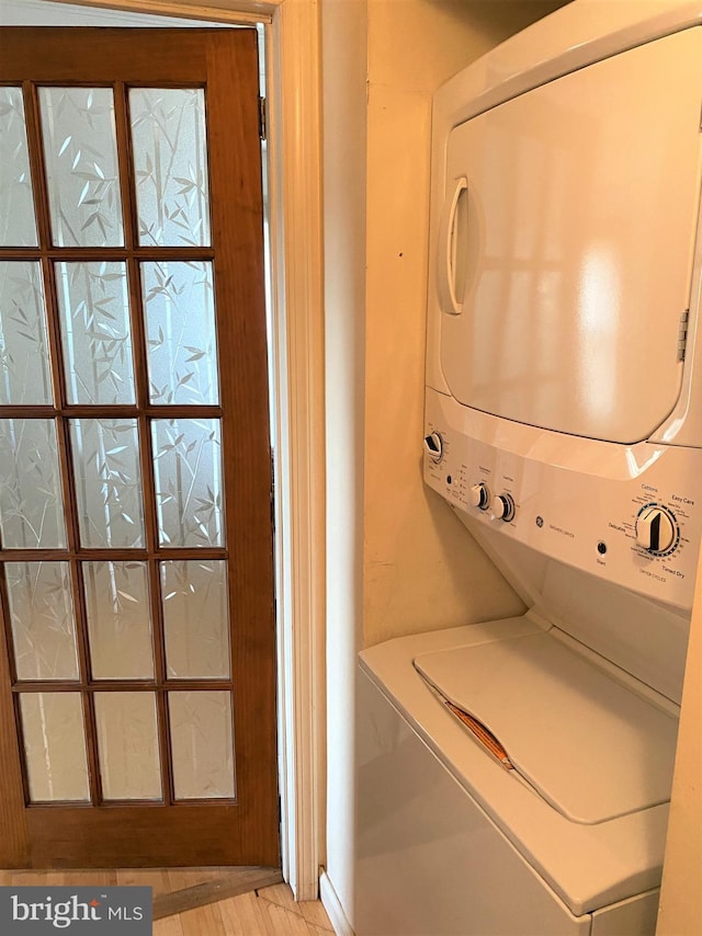 laundry room featuring stacked washer and clothes dryer and laundry area