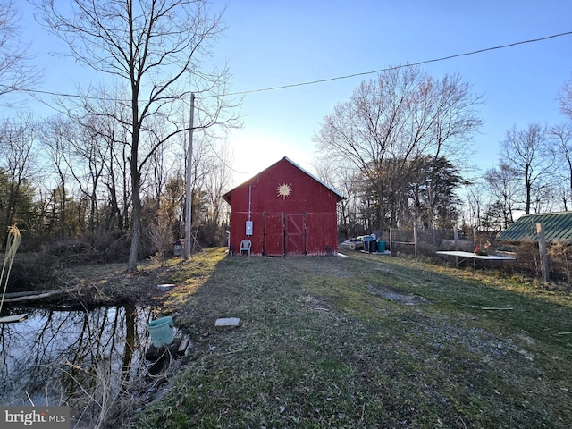 view of yard with an outdoor structure and a barn