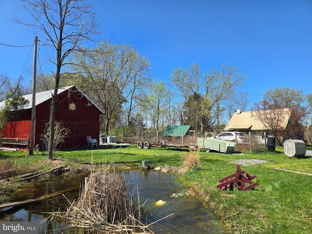 view of yard with an outbuilding and a barn