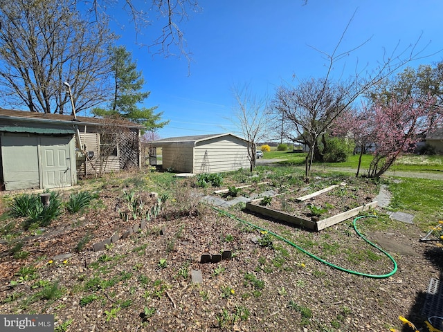 view of yard with a storage unit, an outbuilding, and a garden
