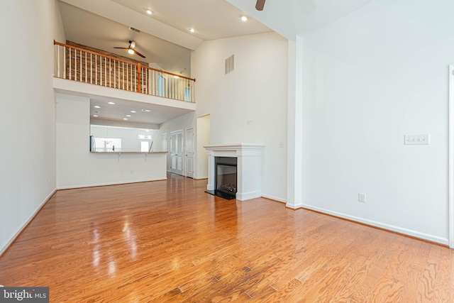 19062 Timbercreek Dr Unit 46, Milton, DE 19968 - unfurnished living room with visible vents, high vaulted ceiling, wood finished floors, and a ceiling fan
