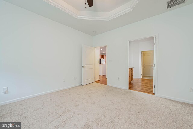 19062 Timbercreek Dr Unit 46, Milton, DE 19968 - unfurnished bedroom featuring visible vents, crown molding, baseboards, a raised ceiling, and carpet floors