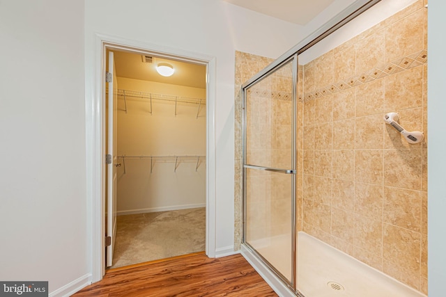 19062 Timbercreek Dr Unit 46, Milton, DE 19968 - full bath with a spacious closet, baseboards, a shower stall, visible vents, and wood finished floors