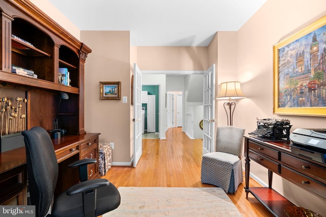 office featuring light wood-style flooring and baseboards