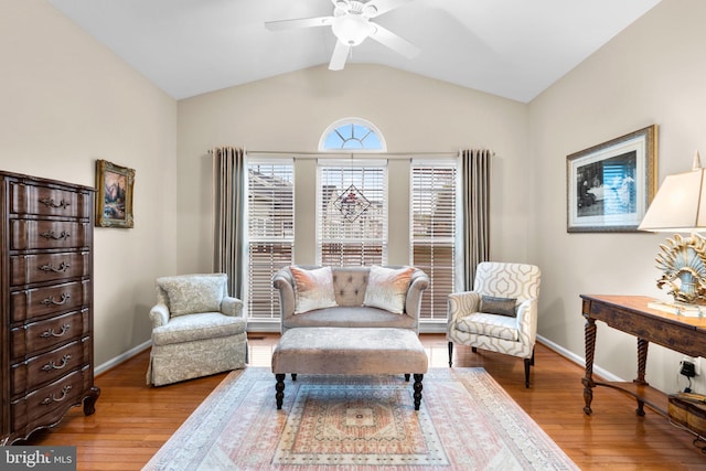 sitting room featuring ceiling fan, baseboards, wood finished floors, and lofted ceiling