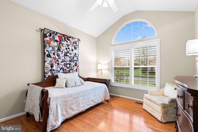 bedroom featuring baseboards, wood-type flooring, and lofted ceiling