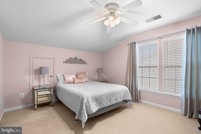 bedroom featuring baseboards, vaulted ceiling, visible vents, ceiling fan, and light colored carpet