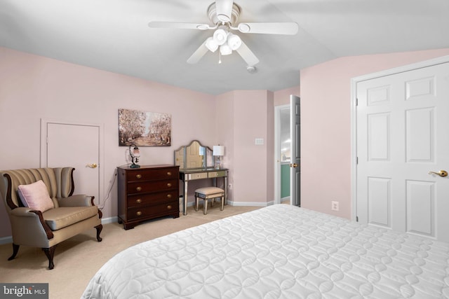 bedroom with baseboards, light colored carpet, vaulted ceiling, and a ceiling fan