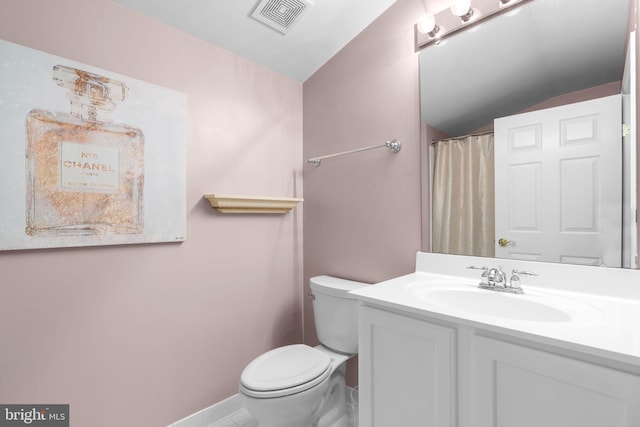 bathroom featuring visible vents, baseboards, toilet, vanity, and lofted ceiling