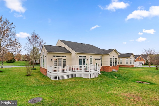 back of property featuring a yard and a deck