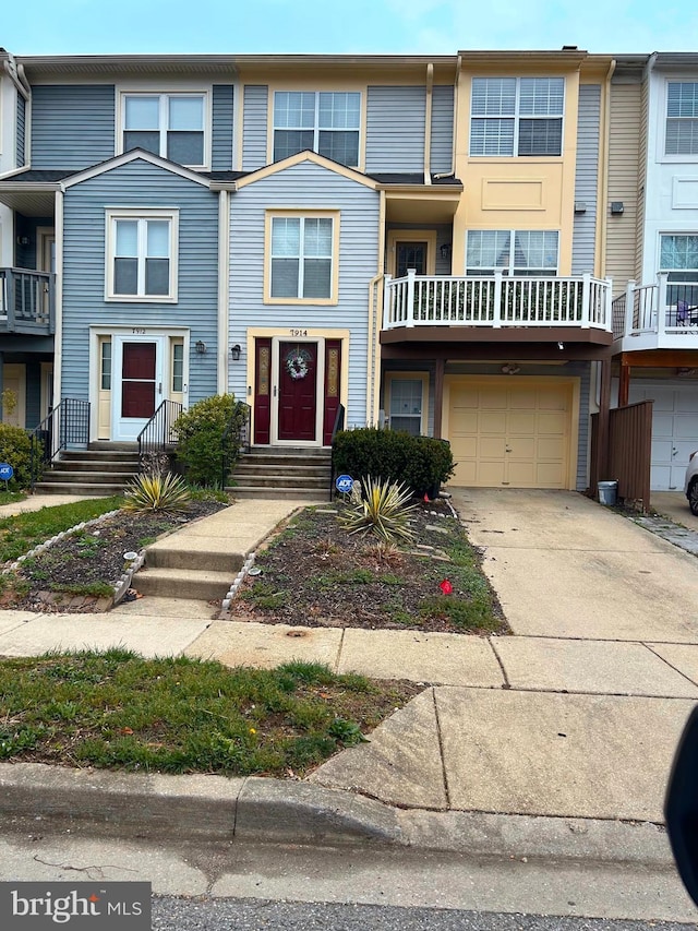 multi unit property with an attached garage and driveway