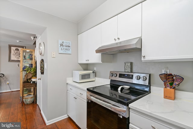 kitchen featuring white cabinets, dark wood-style floors, under cabinet range hood, white microwave, and stainless steel electric stove