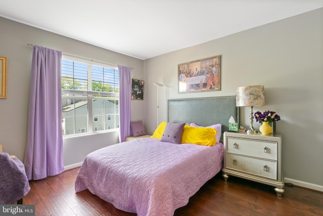 bedroom with baseboards and hardwood / wood-style flooring