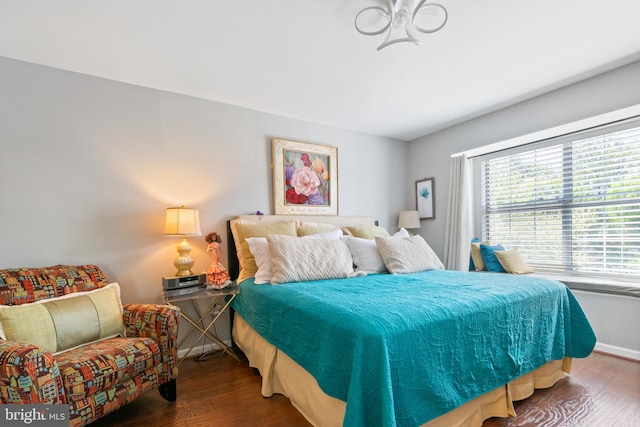 bedroom featuring wood finished floors and baseboards