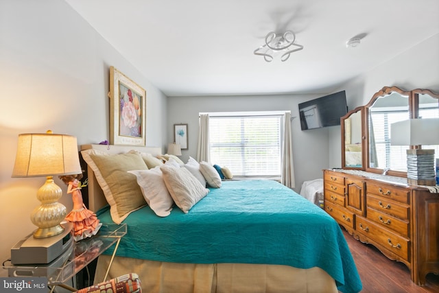 bedroom featuring dark wood-style flooring