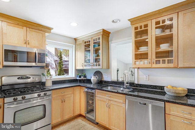kitchen featuring a sink, appliances with stainless steel finishes, beverage cooler, and light brown cabinetry
