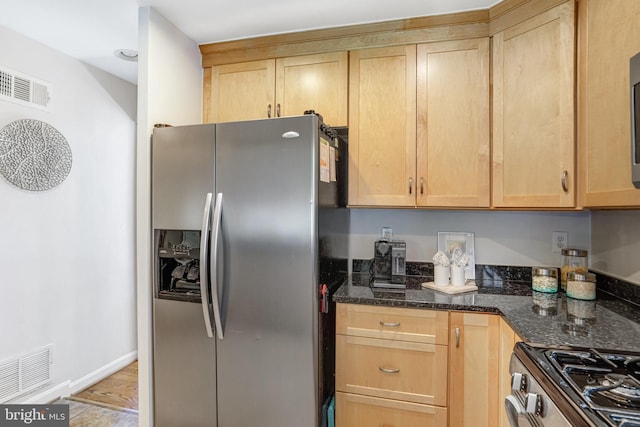 kitchen with stainless steel appliances, visible vents, and light brown cabinets