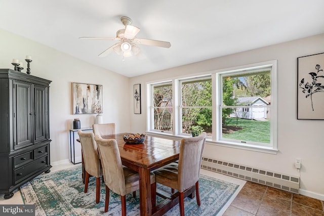 dining room featuring a baseboard radiator, a ceiling fan, baseboards, and lofted ceiling