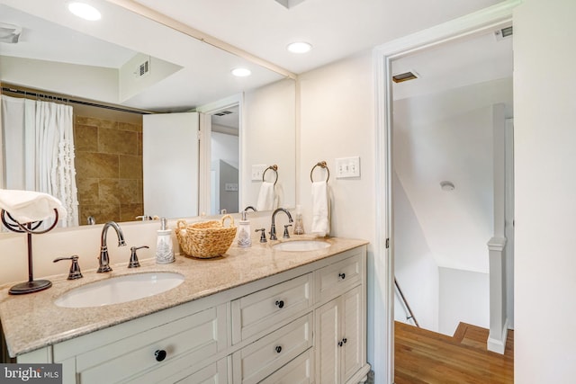 bathroom featuring a sink, visible vents, and double vanity