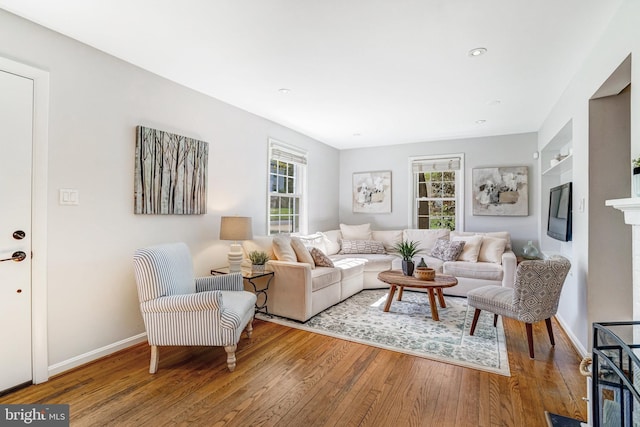 living room featuring a wealth of natural light, hardwood / wood-style floors, and baseboards