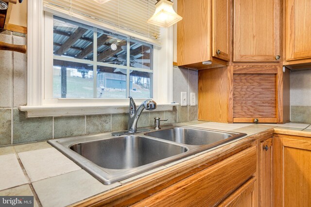 kitchen featuring light countertops and a sink