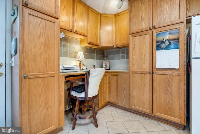 home office with light tile patterned flooring and built in study area