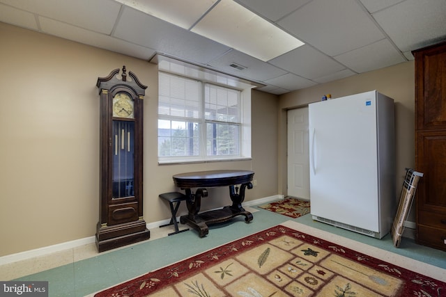 interior space with baseboards, visible vents, and a drop ceiling