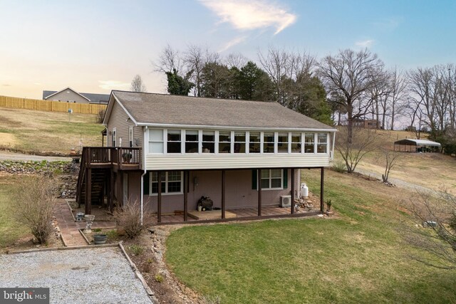 view of front of house featuring stairway, fence, a wooden deck, a patio, and a front lawn
