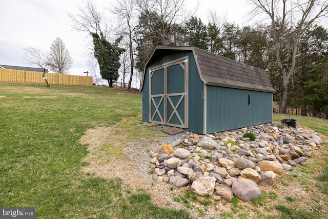 view of shed featuring fence